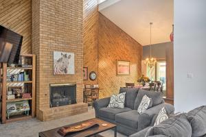 a living room with a couch and a fireplace at Lubbock Townhome with Grill Near TTU and Downtown! in Lubbock