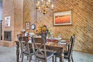 a dining room with a table with flowers on it at Lubbock Townhome with Grill Near TTU and Downtown! in Lubbock