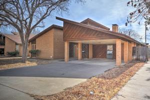 a large brick house with a large garage at Lubbock Townhome with Grill Near TTU and Downtown! in Lubbock