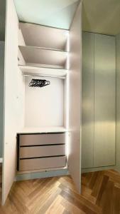 an empty closet with white walls and white shelves at New Luxury Apartment Vienna in Vienna