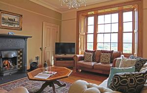 a living room with a couch and a fireplace at Follions Farmhouse in Morpeth