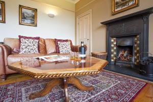 a living room with a couch and a fireplace at Follions Farmhouse in Morpeth