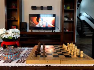 a chess board on a table in front of a television at Vila Irina in Podu Coşnii