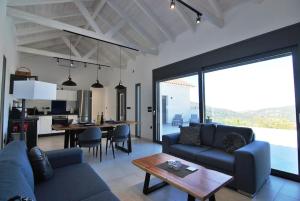 a living room with a blue couch and a table at Villa Katerina Kefalonia in Kefallonia