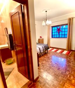 a bedroom with a bed and a window and a door at Spray B&B Sitio in Nazare, European style in Nazaré