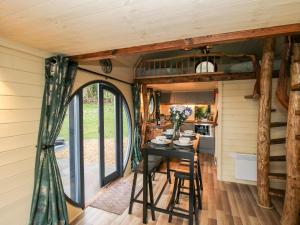 a dining room and kitchen in a tiny house at Callow Pod in Shrewsbury