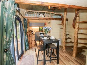 a dining room with a table in a tiny house at Callow Pod in Shrewsbury