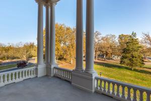 une véranda avec colonnes et vue sur un parc dans l'établissement Inn at Blackstone, à Blackstone