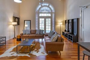 a living room with two couches and a large window at Inn at Blackstone in Blackstone