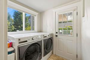 a laundry room with a washing machine and a window at Beautiful 5 bedroom home just steps from the beach in Santa Cruz