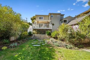 a house with a balcony and a yard at Beautiful 5 bedroom home just steps from the beach in Santa Cruz