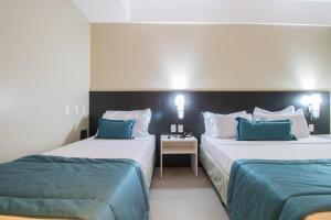 Postel nebo postele na pokoji v ubytování Acqua Prime Maceió Ponta Verde