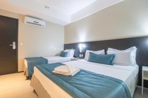 Postel nebo postele na pokoji v ubytování Acqua Prime Maceió Ponta Verde