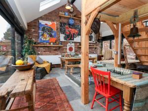 a living room with a wooden table and a chess board on it at Smithy Cottage in Wrexham