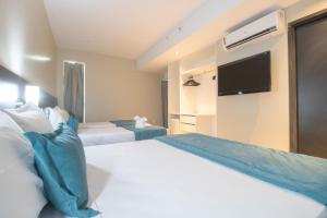 Postel nebo postele na pokoji v ubytování Acqua Prime Maceió Ponta Verde
