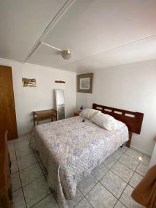 a bedroom with a bed in a white room at Rincon de Las Condes in Santiago