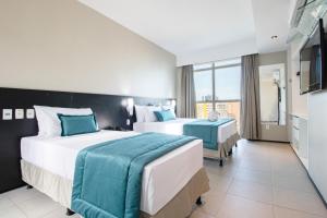 Postel nebo postele na pokoji v ubytování Acqua Prime Maceió Ponta Verde