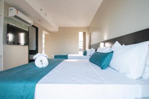 Postel nebo postele na pokoji v ubytování Acqua Prime Maceió Ponta Verde