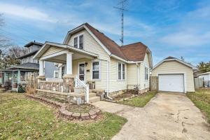 a white house with a porch and a driveway at Charming Urbana Home Near Downtown! in Urbana