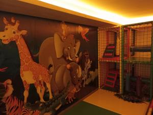 a room with a mural of animals on the wall at Milmari N Lux 52 in Kopaonik