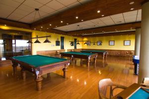 a room with three pool tables in a gym at Hotel y Cabañas Llanuras de Diana - Caja Los Andes in Puerto Natales
