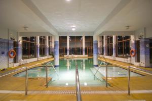 a large indoor swimming pool in a building at Hotel y Cabañas Llanuras de Diana - Caja Los Andes in Puerto Natales