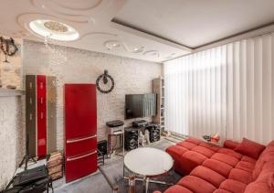 a living room with a red couch and a table at Lipno Pearl in Lipno nad Vltavou