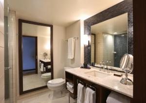 a bathroom with a sink and a toilet and a mirror at InterContinental New York Times Square, an IHG Hotel in New York