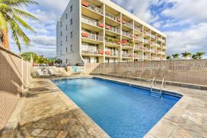 a swimming pool in front of a building at Condo with Private Lanai, Ocean View and On-Site Pool! in Kihei