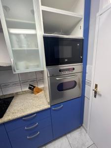 a kitchen with a stove and a microwave at Croatia Home in Velika Gorica