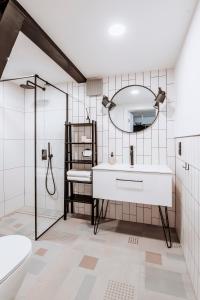 a bathroom with a sink and a mirror at Długa Design Apartment - Old Town in Gdańsk