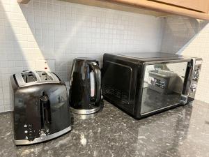 a kitchen counter with a toaster and a coffee maker at New Two Bedroom Premium Apartment - Skylight - Northampton Town Centre in Northampton