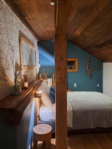 a bedroom with a large bed and a wooden ceiling at La Maïta in Montgenèvre