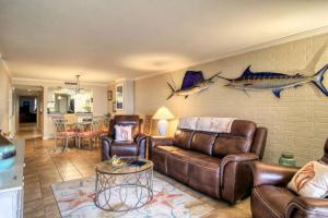 a living room with leather furniture and a wall with fish on it at 2 Bedroom with Den and 3 Bathrooms Elegant view of The Gulf of Mexico in Port Aransas