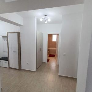 ein leeres Zimmer mit weißen Wänden und einem Spiegel in der Unterkunft Neue, moderne Penthousewohnung Sighisoara in Sighişoara