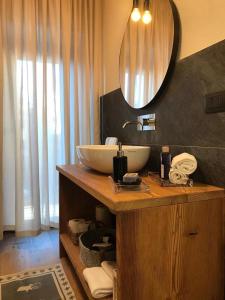 a bathroom with a sink and a mirror on a counter at 4Seasons appartamenti in Sauze dʼOulx