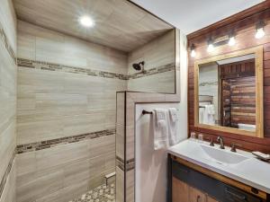 a bathroom with a sink and a mirror at Cartier Mansion in Ludington