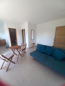 sala de estar con sofá azul y mesa en Casa Bacoba, en Santa Marta