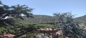 a view of a city with mountains in the background at DEPARTAMENTO VILLA CARLOS PAZ CENTRO in Villa Carlos Paz