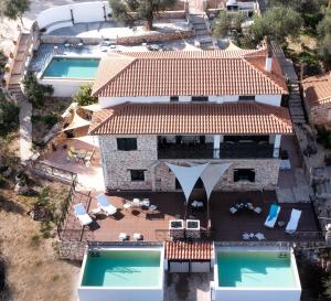 an aerial view of a house with two swimming pools at Xigia Escape villas in Khartáta