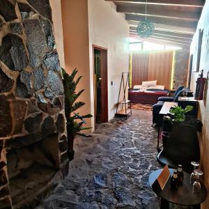 a living room with a stone fireplace and a couch at No 1 Loft Jacuzzi Mazamitla in Mazamitla