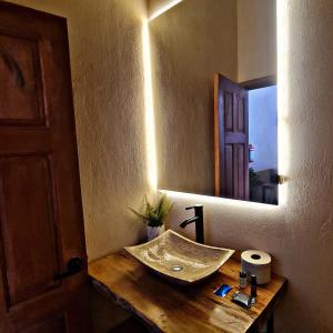 a bathroom with a sink and a mirror at No 1 Loft Jacuzzi Mazamitla in Mazamitla