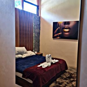 a bedroom with a bed and a picture of a woman at No 1 Loft Jacuzzi Mazamitla in Mazamitla +9 photos