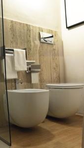 a bathroom with a toilet and a bidet at Domus '400 in Pisa