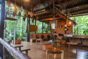 a restaurant with tables and chairs in a forest at Jamu Lodge in the Cuyabeno Wildlife Reserve in Cuyavenus +28 photos