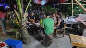 a group of people sitting at a table in a restaurant at Treasure Beach Resort in Carles