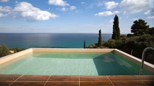 a swimming pool with a view of the ocean at Xigia Escape villas in Khartáta