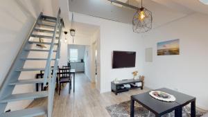 a living room with a staircase and a dining room at Apartmenthaus Celik in Bielefeld