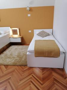 - une chambre avec un lit blanc et du parquet dans l'établissement Apartma Tanya Bled, à Bled