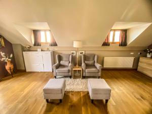 two chairs and a table in a living room at Ararat Penthouse in Zlatibor